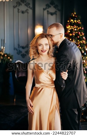 A guy with a girl is celebrating Christmas. A loving couple enjoy each other on New Year's Eve. New Year's love story