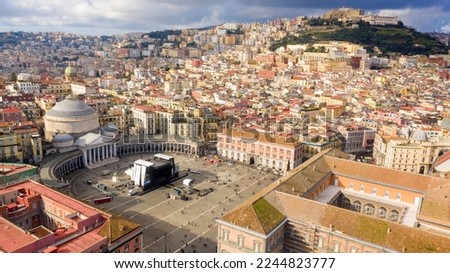 Aerial view of Piazza del Plebiscito, a large public square in the historic center of Naples, Italy. It's bounded by San Francesco di Paola' s church. In background Castel Sant' Elmo and Vomero hill. Royalty-Free Stock Photo #2244823777