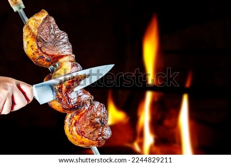 Steak rotisserie at the steakhouse, sliced picanha Royalty-Free Stock Photo #2244829211