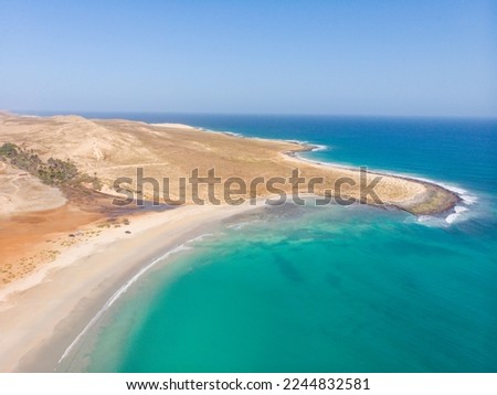 Coast of Boa Vista - paradise island next to the west coast of Africa. Nice waves and surf around the shore of Cape Verde island. Drone image of the Boa vista coast. Perfect sunny weather! Royalty-Free Stock Photo #2244832581