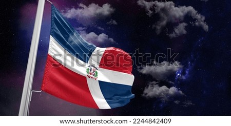 Dominican Republic national flag cloth fabric waving on beautiful Blue Background.