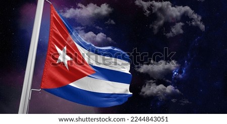 Cuba national flag cloth fabric waving on beautiful Blue Background.