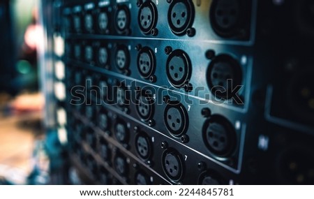 Music mixer panel with microphone ports in recording studio closeup. Professional musical equipment console with mic connectors for song production
