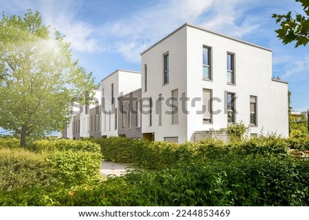 Cityscape with modern townhouses in a residential area, new apartment buildings with green outdoor facilities in sustainable enviroment Royalty-Free Stock Photo #2244853469