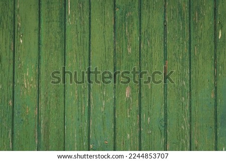 Vertical green vintage weathered textured paint chipped wood panel wall for background texture in any abstract scene