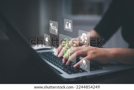 Businessman using laptops and touch recycle symbol with virtual modern reduce CO2 emission concept with icons, global warming emissions carbon footprint climate change to limit global warming, energy Royalty-Free Stock Photo #2244854249