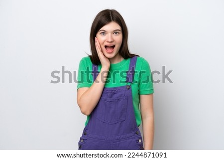 Young Russian woman isolated on blue background with surprise and shocked facial expression