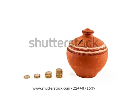 Stacked coins or money Clay pot jug money box, penny or piggy bank. Saving  and Clay pot jug money box. Saving money coin for healthcare, new house home, future, school, college, holiday. 