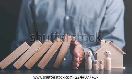 Human hand blocking wooden blocks,Represents protection and protection of safety,concept of insurance management planning To ensure both health and financial safety,Property and Family Risk Reduction Royalty-Free Stock Photo #2244877419