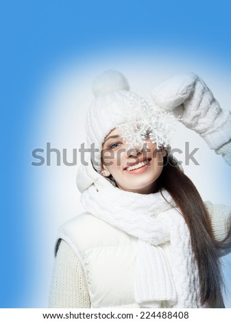 beauty face portrait of attractive young caucasian woman in warm clothing  studio shot isolated on white toothy smiling winter snowflake
