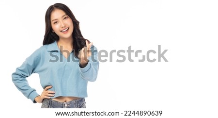 Smiling young girl showing mini heart with hand sign, love sign Isolated over white background Portrait young beautiful asian woman hand gesturing in heart shape Smile face asian girl get in love