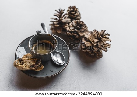 Elegant espresso coffee served with cookies standing next to four cones. Gray background. Copy space. . High quality photo