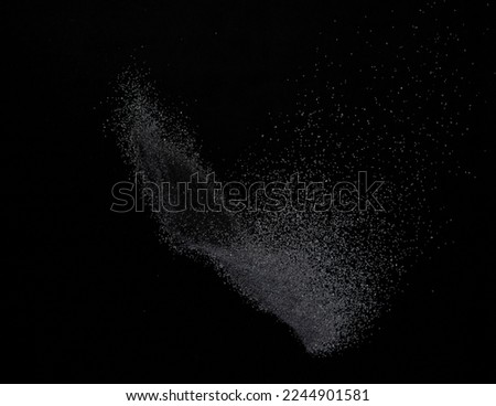 Million of black sand explosion, Photo image of falling down sands flying. Freeze shot on black background isolated overlay. Tiny Fine sand dust magnet as particle disintegrate science Royalty-Free Stock Photo #2244901581