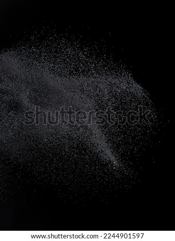 Million of black sand explosion, Photo image of falling down sands flying. Freeze shot on black background isolated overlay. Tiny Fine sand dust magnet as particle disintegrate science Royalty-Free Stock Photo #2244901597