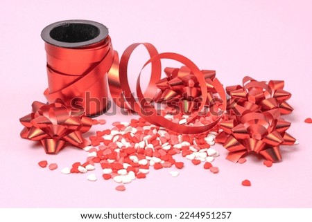 Valentine's hearts with red bows and red curly ribbon. Valentine's Day