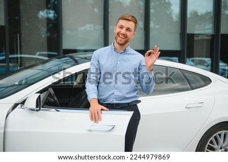 Always available. Handsome young businessman near his car outdoors.