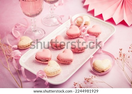 Happy Mothers Day, Happy Valentine - sweet macarons in heart shape and glasses of rose sparkling wine in pink tone Royalty-Free Stock Photo #2244981929