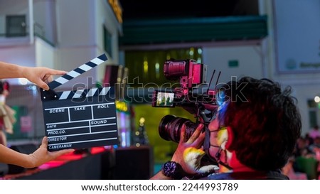 Man hands holding movie clapper.Film director concept.camera show viewfinder image catch motion in interview or broadcast wedding ceremony, catch feeling, stopped motion in best memorial day concept. Royalty-Free Stock Photo #2244993789