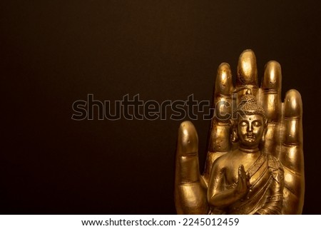 Relaxing and zen atmosphere with candles. Buddha statue on black background.	