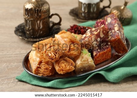 Tea, baklava dessert and Turkish delight served in vintage tea set on wooden table