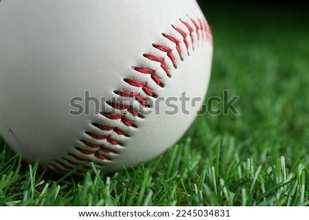 Baseball ball on green grass, closeup. Sports game