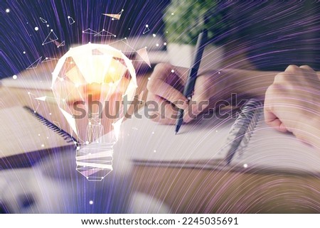 Drawing bulb over woman's hands taking notes background. Concept of idea. Double exposure