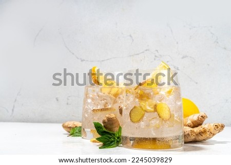 Refreshment Ginger Ale cocktail, Kombucha or Lemon Ginger iced lemonade drink. Sweet and sour alcohol drink copy space Royalty-Free Stock Photo #2245039829