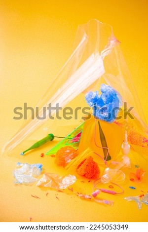 plastic trash on bright yellow background