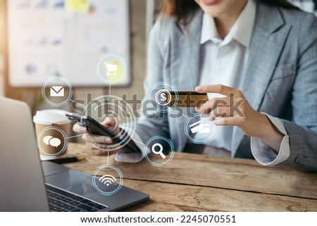 Women pay with a credit card on a smartphone with a virtual icon.