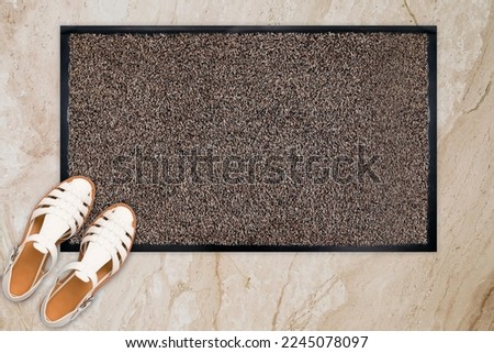 Designer Welcome Entry Doormat Placed on Marble Floor with White Ladies Sandles