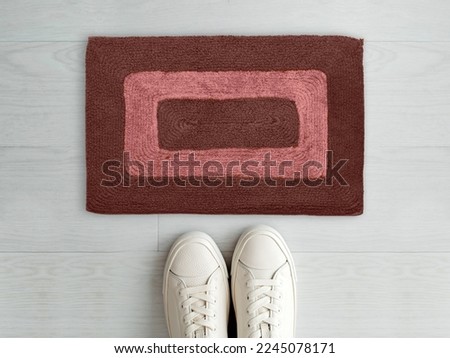 Designer Welcome Entry Doormat Placed on White Floor with White Shoes