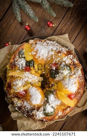 Bolo do Rei or King's Cake, Made for Christmas, Carnavale or Mardi Gras with Christmas season elements in Background.