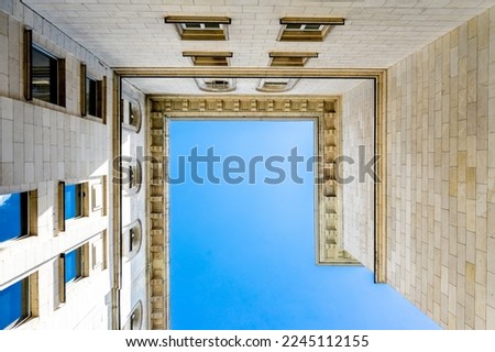 Looking up at an old building under a blue sky
