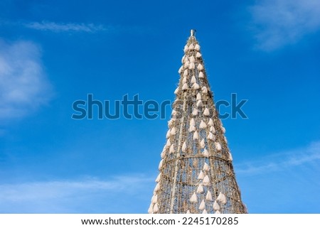 Closeup of a Christmas Tree (high section, photography) against a clear blue sky with copy space. Plaza Mayor (main square), Madrid downtown, Spain, southern Europe.