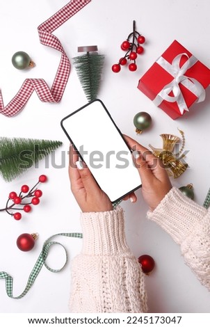 A vertical Christmas mockup on white background with a phone with a blank screen in the center 