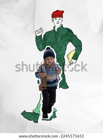 Happy cute kid wearing warm winter clothes running over drawn portrait of dancing man. Concept of inner child, childhood and dreams. Happiness, carefreeness, fun