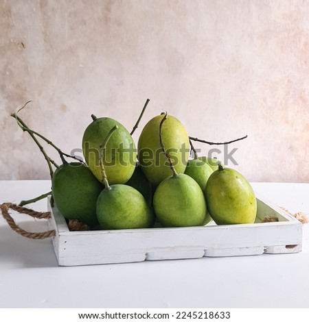 Delicious mango fruit on the table. Scientific name: Mangifera, Family: Anacardiacea