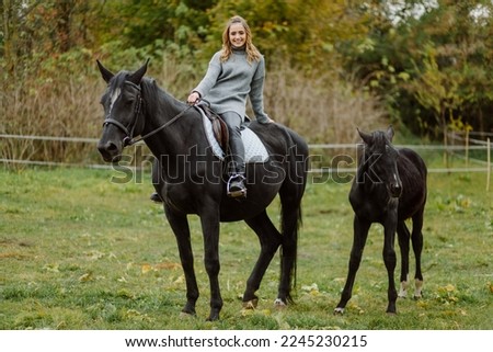 Woman on a horse at rancho. Horse riding, hobby time. Concept of animals and human
