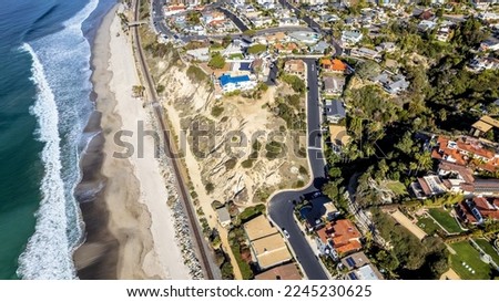 Ariel view of Boco Bluffs in San Clemente, CA.  Coastline, beach, railroad tracks, pacific ocean and ocean view homes in shot Royalty-Free Stock Photo #2245230625