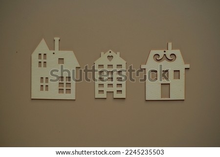 Remote work at home. Flat wooden house on biege background view from above. Blurred background