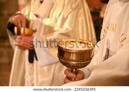 Priest gives holy communion to prayers in cathedral. Midnight Holy Mass on Christmas Eve. Prayer receive the host or bread in church. Eucharist.