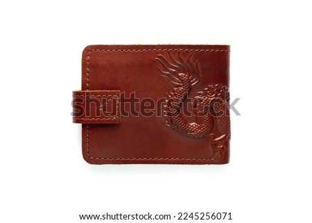 Brown leather wallet on a button on a white background. Top view. Dragon print
