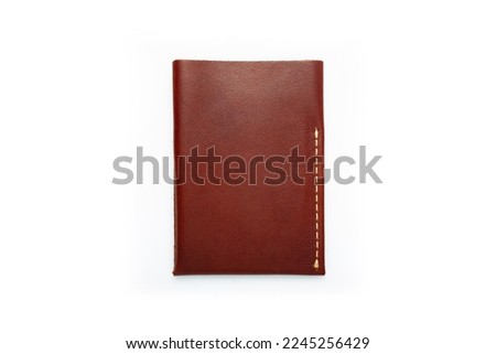 Brown leather wallet on a button on a white background. Card holder. Top view