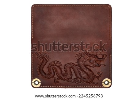 Big brown leather wallet on a button on a white background, dragon print. Top view