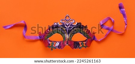 Beautiful carnival mask on orange background