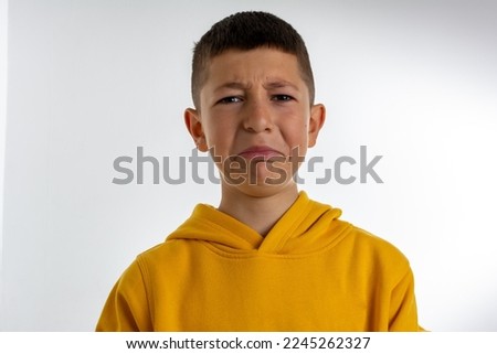sad offended little boy. Portrait of a sad upset little boy crying isolated over white background. Beautiful cute little child crying isolated on white background. Royalty-Free Stock Photo #2245262327