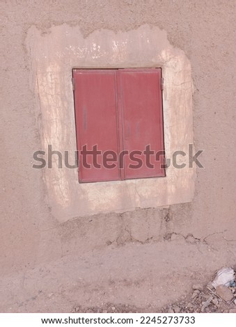 A picture of the door of a small red shop in the city of Mmzoda 