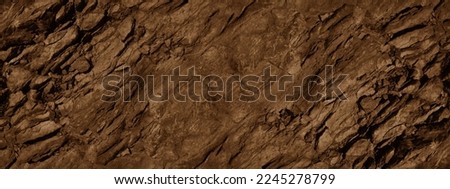Red brown stone background with space for design. Rock surface texture. Cracked, crumbled, crushed. Rough.  Close-up. Banner. Wide. Long. Panoramic.