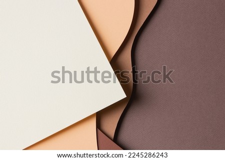 Abstract colored paper texture background. Minimal paper cut style composition with layers of geometric shapes and lines in shades of beige and brown colors. Top view Royalty-Free Stock Photo #2245286243