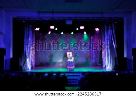 Texture blur and defocus. Stage color light at a concert show. Artists perform on scene in light and smoke.